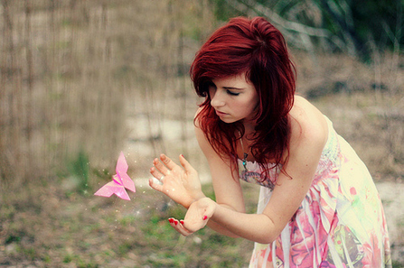 spiritual woman catching pink butterly