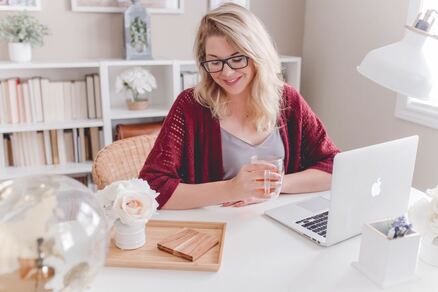 happy woman in modern white home office