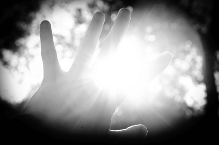 hand reaching into light