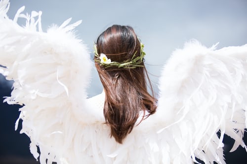 woman as angel with white feather wings