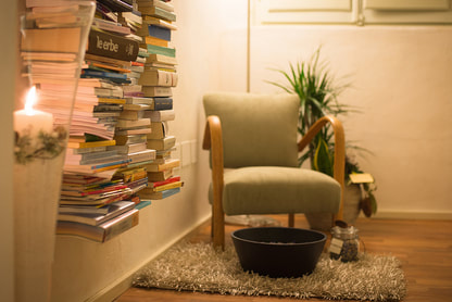 sacred space corner of room with books, candle, chair