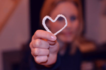 woman holding white heart shape