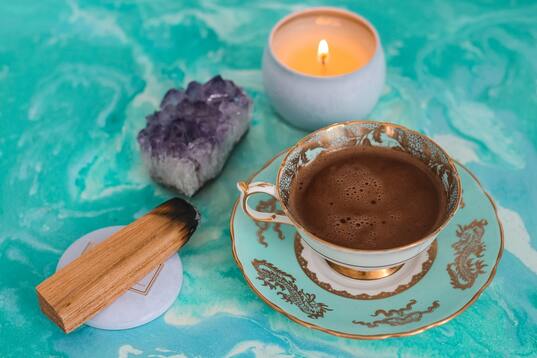 amethyst crystal, coffee cup on sacred table