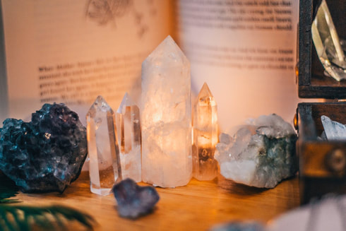 crystals, candle and book sacred space