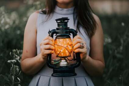 woman holding lantern of light