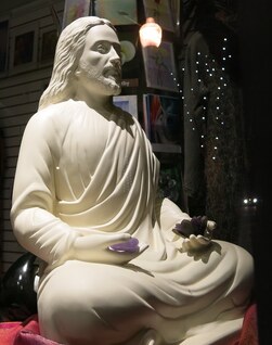 jesus meditating holding crystals statue