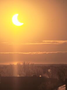 partial solar eclipse, view from house and forest