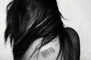 woman with Slave barcode tattoo
