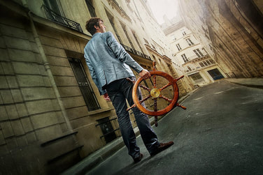 man holding ship wheel on street 