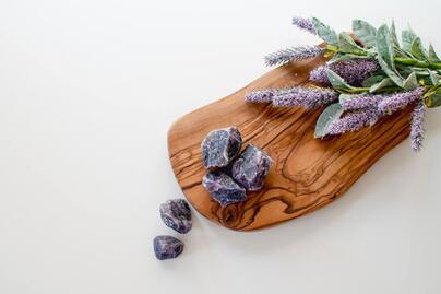 fresh lavender and purple crystals on wooden board
