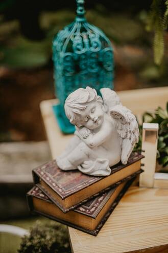 sacred table with books, angel statue