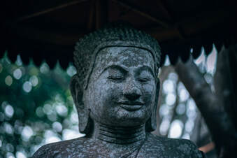 peaceful buddha statue smiling eyes closed
