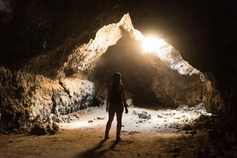 woman in cave with light