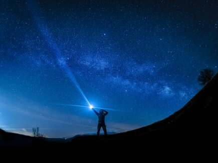 man and light in blue cosmos sky