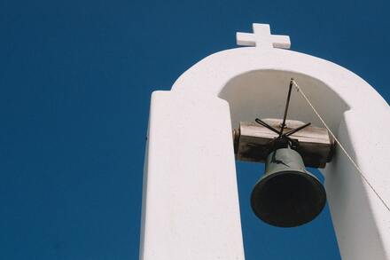 cross and bell on church top