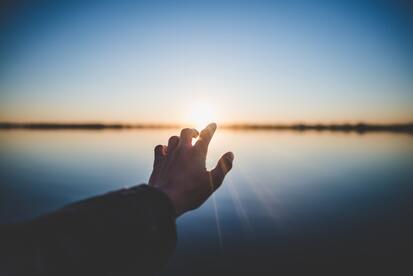hand reaching out to light, God