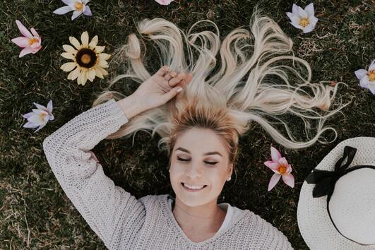 happy spiritual woman lying on grass