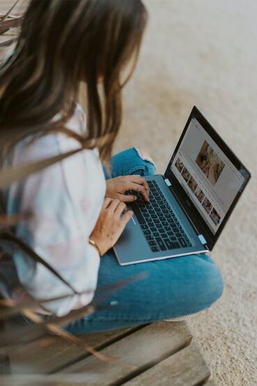 woman sitting on floor on laptop, online learning