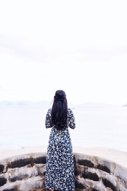 woman looking out to ocean